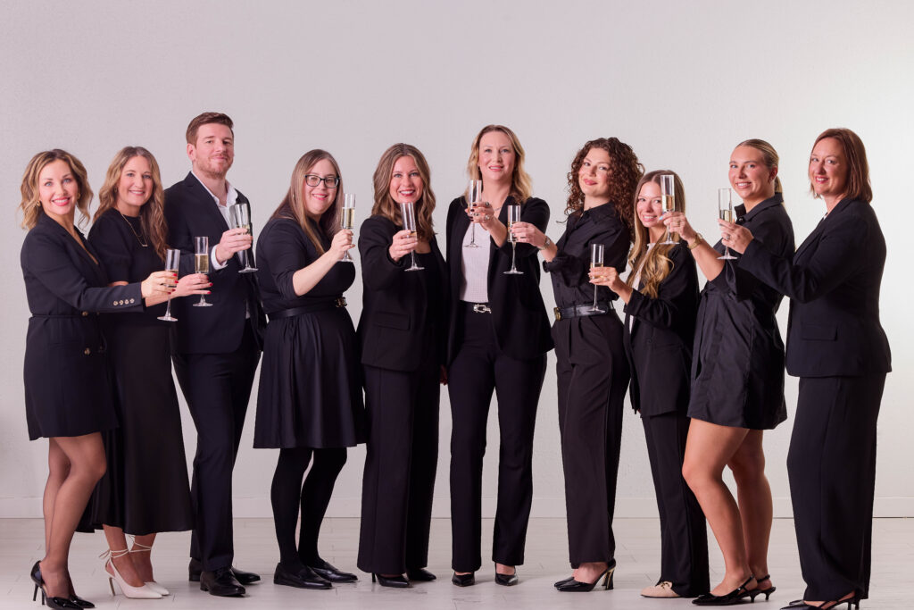 A portrait of the entire Arrow marketing team wearing black on a white background.